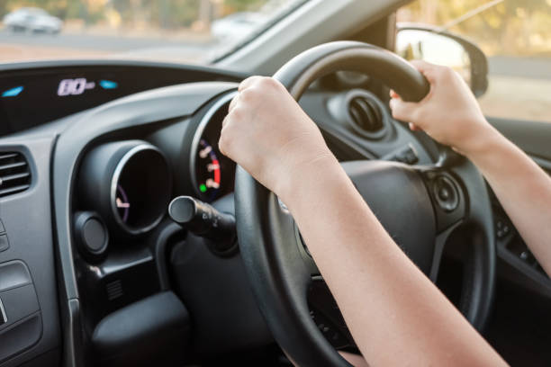 istock Woman's hands on car steering wheel 1166813354