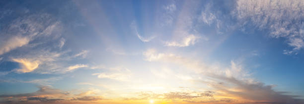 istock Sunset cloudy sky with the orange sun 1166813395