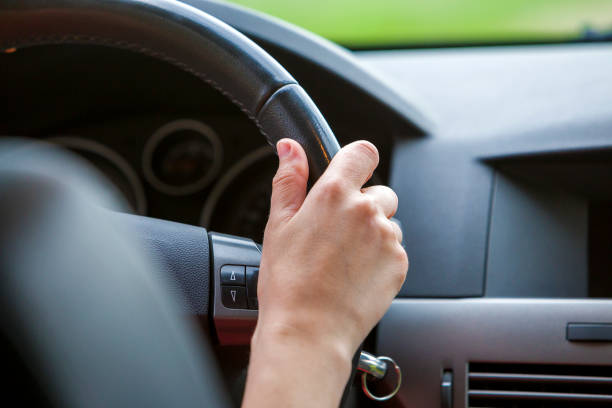 istock Woman hands on steering wheel driving a car. 1166813407