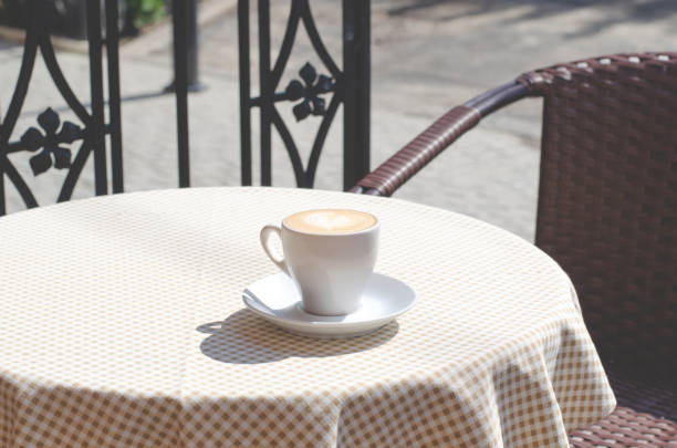 istock A cup of coffee on the table with a checkered tablecloth. 1166814257