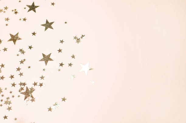 istock Light golden background with many shiny stars. 1166814336