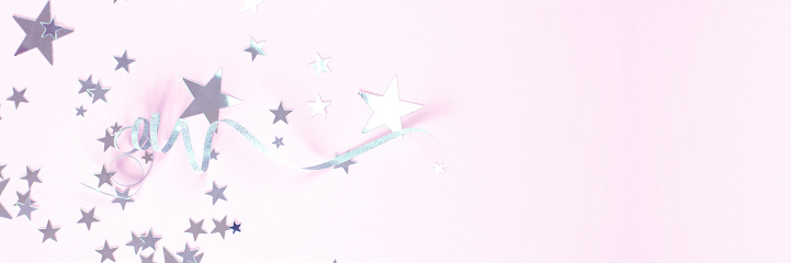 Pink background with silver curls and stars. Web banner for the site.