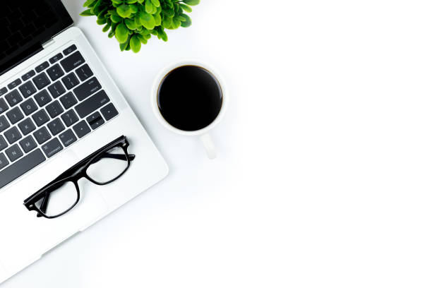 istock Modern white office desk table with laptop computer, smartphone with black screen over a notebook and cup of coffee. 1166814524