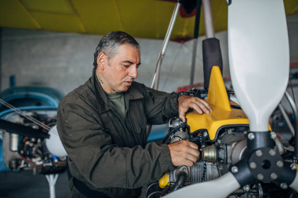 istock Man airplane mechanic repairing airplane 1166814596