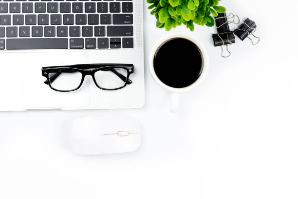istock Modern white office desk table with laptop computer, smartphone with black screen over a notebook and cup of coffee. 1166814671