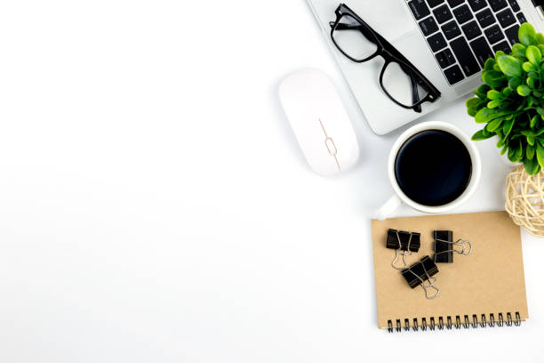 istock Modern white office desk table with laptop computer, smartphone with black screen over a notebook and cup of coffee. 1166814767