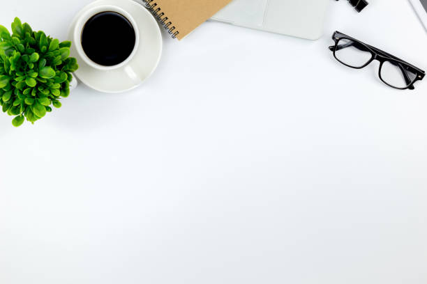 istock Modern white office desk table with laptop computer, smartphone with black screen over a notebook and cup of coffee. 1166814981