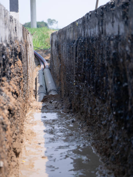 istock installing concrete drains on the side of the road 1166815612