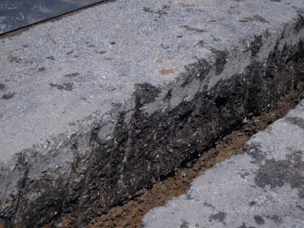 istock installing concrete drains on the side of the road 1166815694