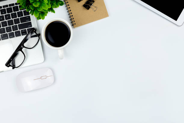 istock Modern white office desk table with laptop computer, smartphone with black screen over a notebook and cup of coffee. 1166815852