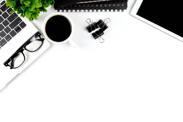 istock Modern white office desk table with laptop computer, smartphone with black screen over a notebook and cup of coffee. 1166816049