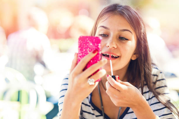 istock Teenage girl doing her makeup 1166816296