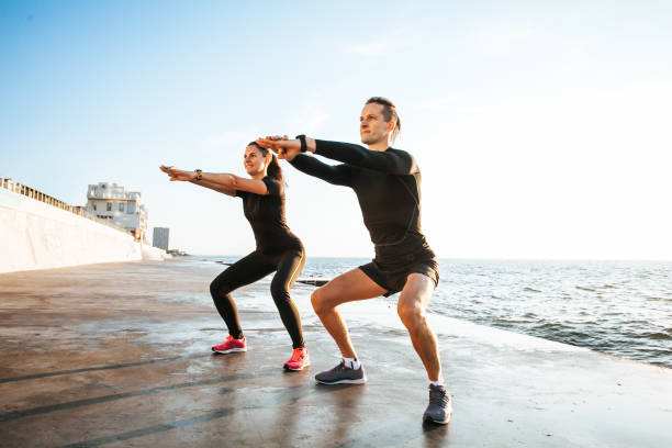 istock Young couple working out outdoors 1166817788