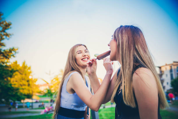 istock Young women with ice creams 1166818524