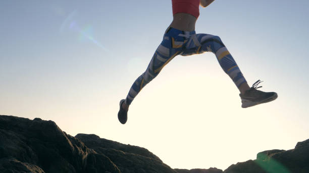istock Training on a rocky shore. Epic jump. Close up on legs 1166820696