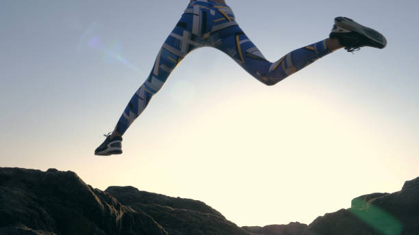 istock Training on a rocky shore. Epic jump. Close up on legs 1166820727
