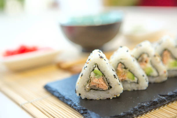 istock Sushi roll with salmon, smoked eel, avocado, cream cheese on black background. Sushi menu. Japanese food. Healthy and tasty food. 1166824581