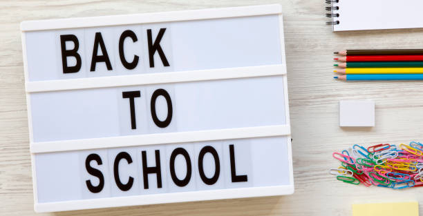 istock 'Back to school' words on a lightbox, accessories for study on a white wooden surface, view from above. Top view, overhead, flat lay. 1166824962