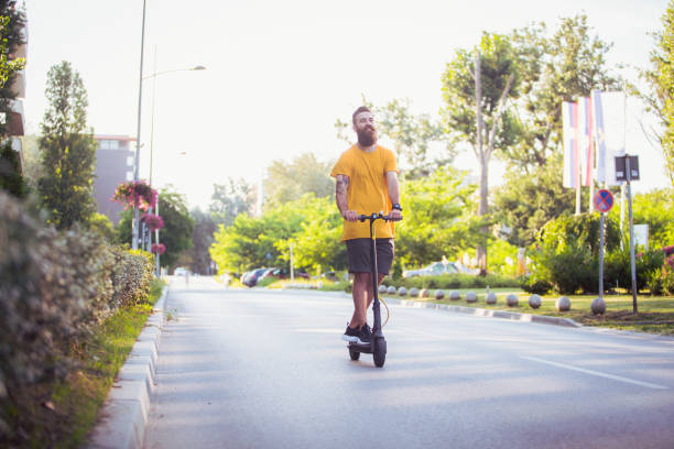 istock Hipster riding a scooter on the road 1166826942