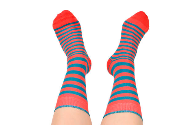 istock Woman in orange socks isolated on white background. Top view. 1166827471