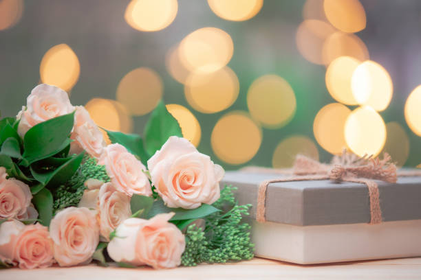 istock Rose flower, gift box, on wooden table with bokeh background 1166827718