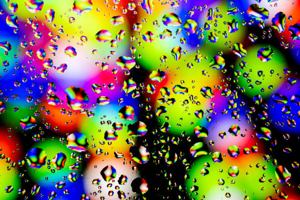 Neon lights behind water drops close up