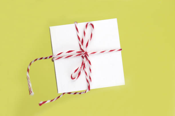 istock levitation  gift box. Flying gift box isolated on yellow background, holiday celebrate 1166830391