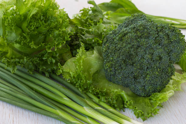 istock Healthy green vegetables: broccoli, lettuce and onions 1166831137