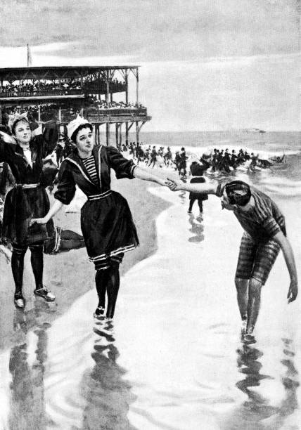 People Playing on the Beach at Asbury Park, New Jersey, United States - 19th Century People playing on the beach at Asbury Park in Monmouth County, New Jersey, USA. Vintage etching circa late 19th century. victorian swimwear stock illustrations