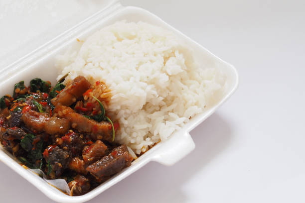 istock Stir-fried Crispy Pork with chilies and holy basil leaf On Rice In Foam Box For Take Home 1166834817