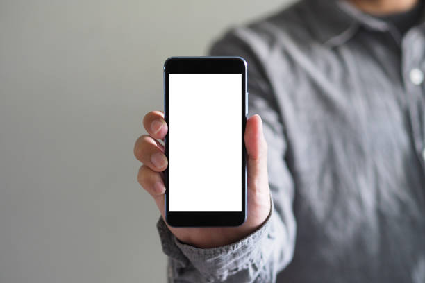 istock Business man showing Smartphone with white screen and Clipping path inside 1166834949
