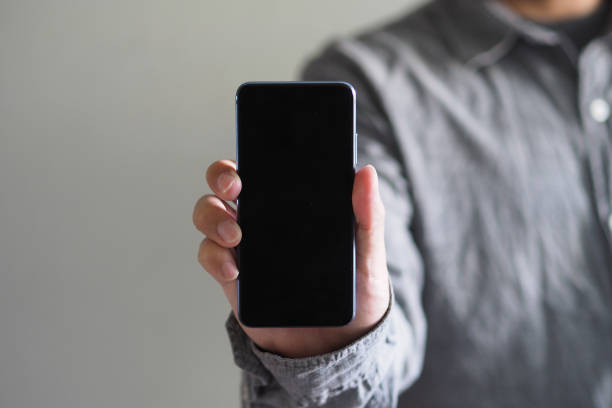 istock Business man showing Smartphone with black screen and Clipping path inside 1166834953
