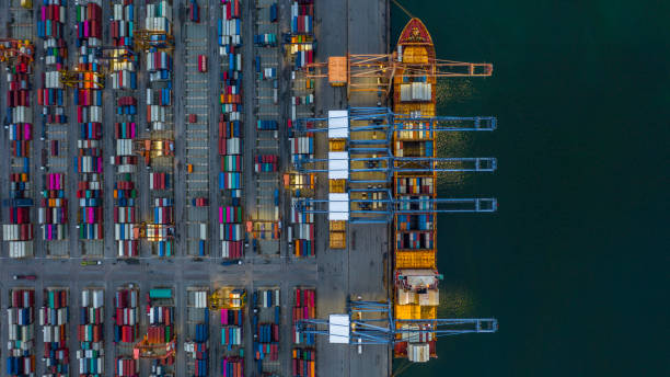 istock Aerial view container ship loading at night in industrial port, container cargo freight ship with industrial crane,  Container ship in import and export business logistic at night. 1166834962