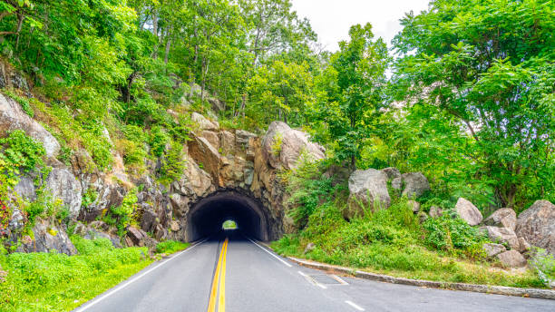 Tunnel through rocks along the skyline drive national park. Tunnel through rocks along the skyline drive national park. The skyline drive is 105 miles long and runs along the blue ridge parkway in the appalachian mountains. blue ridge parkway stock pictures, royalty-free photos & images