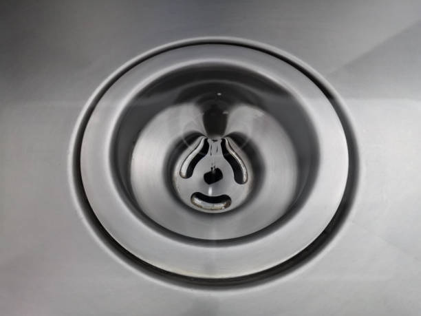 istock Vortex water, whirlpool spinning over drain hole making beautiful abstract circles on Stainless background.Water flows into the drainage hole with a shallow depth of field 1166835253