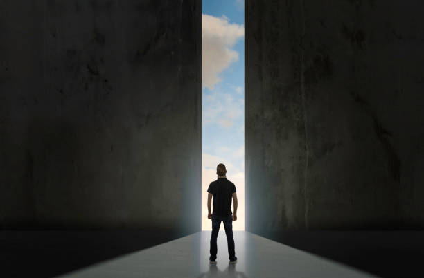 istock Man standing in front of large door 1166837120