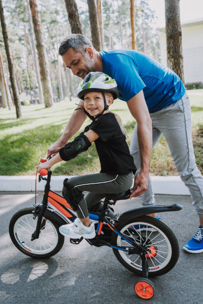istock Father teaching his daughter to ride a bicycle 1166839767