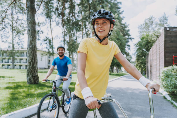 istock Joyful woman enjoying bicycle ride with her husband 1166839781
