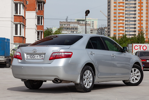 Novosibirsk, Russia - 07.18.2019: Rear view of Toyota Camry 2006 in silver color after cleaning before sale in a sunny day on parking