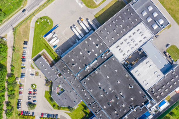 istock Aerial Shot of Industrial Loading Area where Many Trucks Are Unloading Merchandise 1166841965