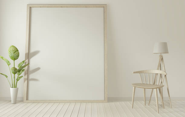 istock mock up poster frame and white chair on white living room.3D rendering 1166843031