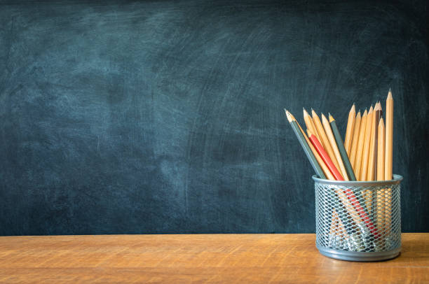 istock Education, Concept back to school and pencils on wooden table, chalkboard background. 1166843533