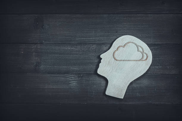 istock Human head and face with cloud sign  on wood table background. Brain of thinking about dream , Symbol of Process and Positive Mind concept 1166844687