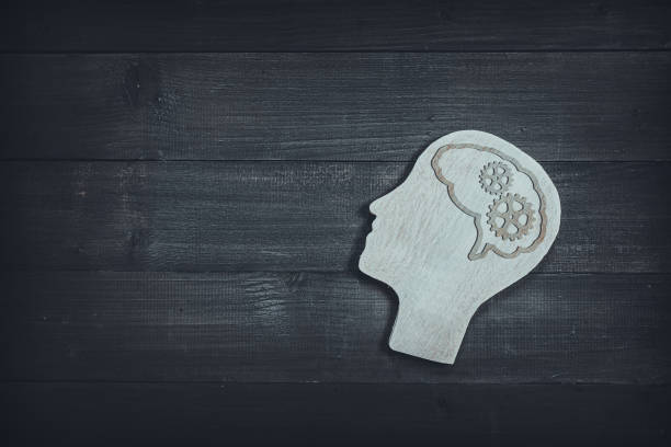istock Human head and face with gear sign  on wood table background. Brain of thinking about driving the organization , Symbol of Process and Positive Mind concept 1166844708