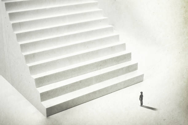 istock beginning a new challenge, man climbing big white stairs 1166845909
