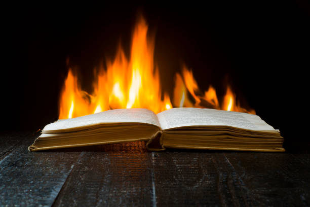 istock Open book on a background of flames 1166845977