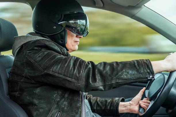 istock a racer with helmet drives a fast car 1166846954