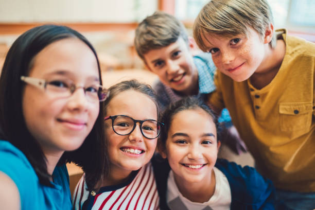 istock School children taking selfie in class 1166850609