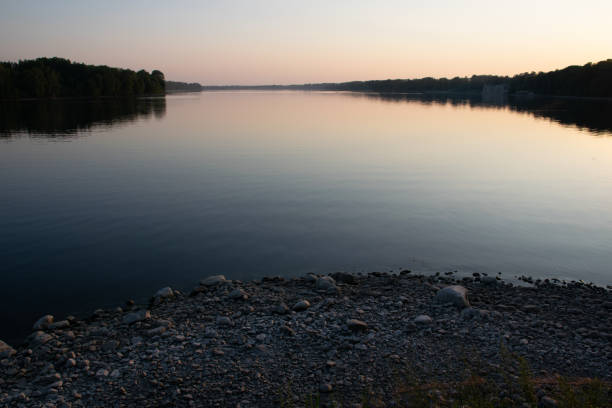 istock Calm river at sunset in summer 1166850729