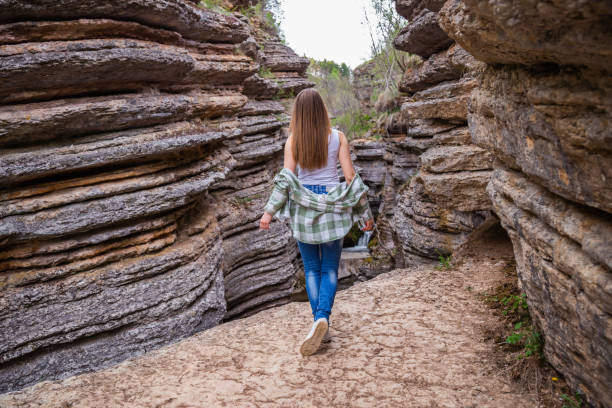 istock Beautiful young woman relaxing in canyon 1166850903